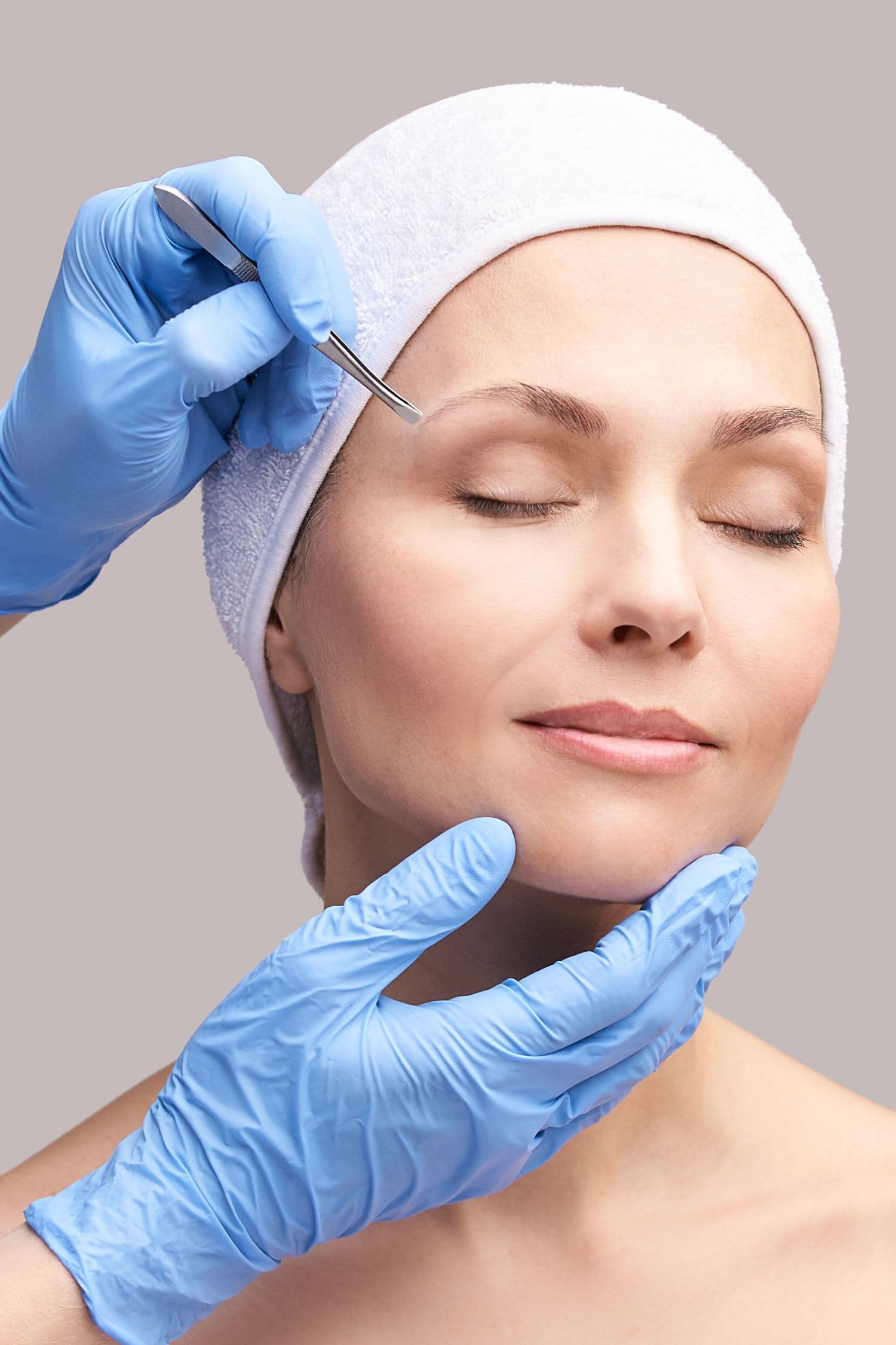 Cosmetic specialist assessing a patient before treatment